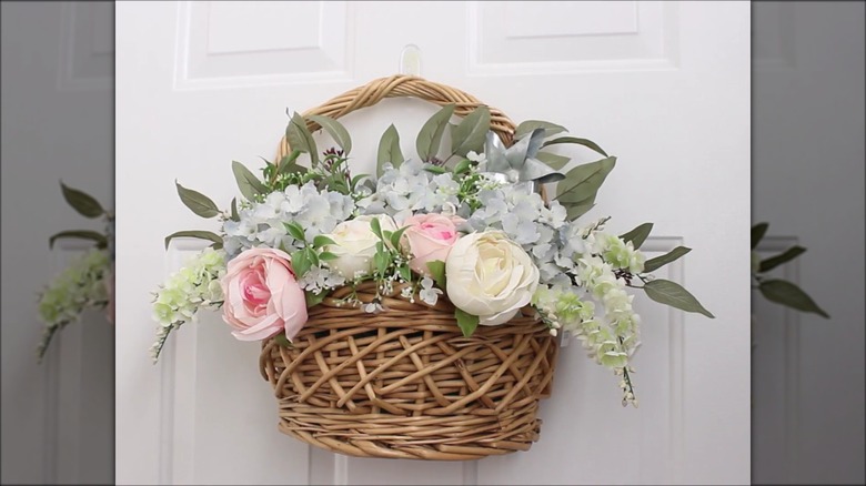 Dried flowers in a wicker basket on a door