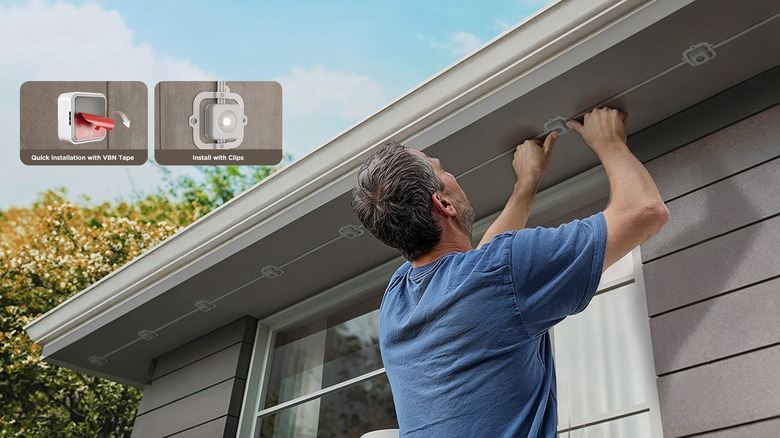 man installing permanent lights