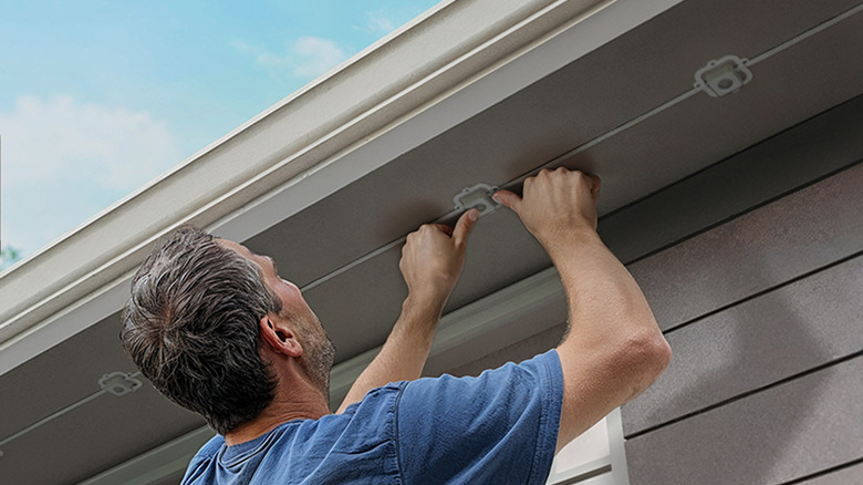 Man installing Govee outdoor lights