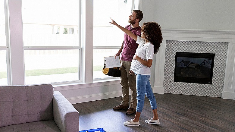 Two people pointing at windows