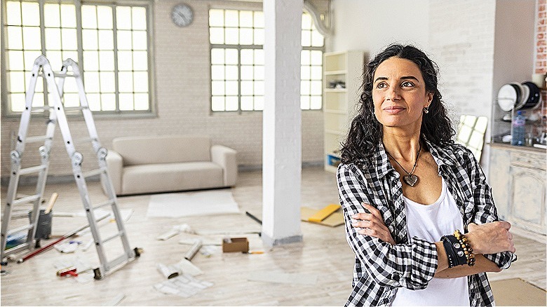 Person observing home repair progress