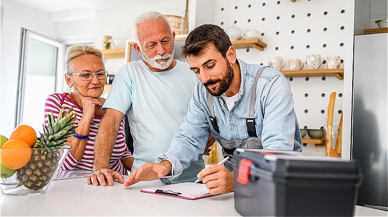 Three people discussing home repairs