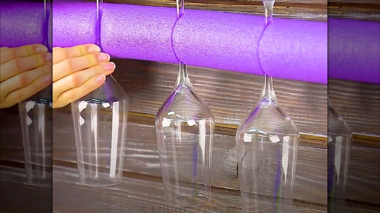 pool noodle holding wine glasses