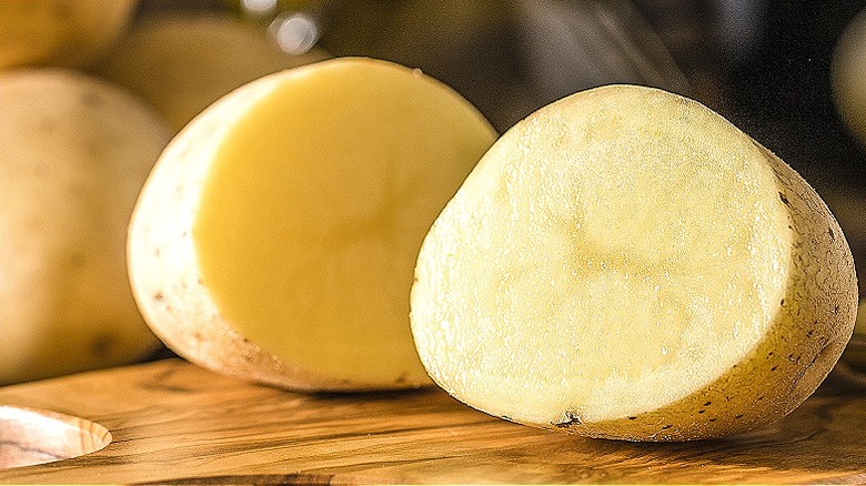 Sliced potato on cutting board