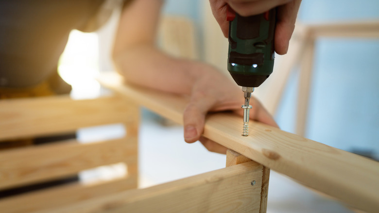 person building wood shelves