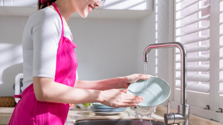 Woman washing dishes