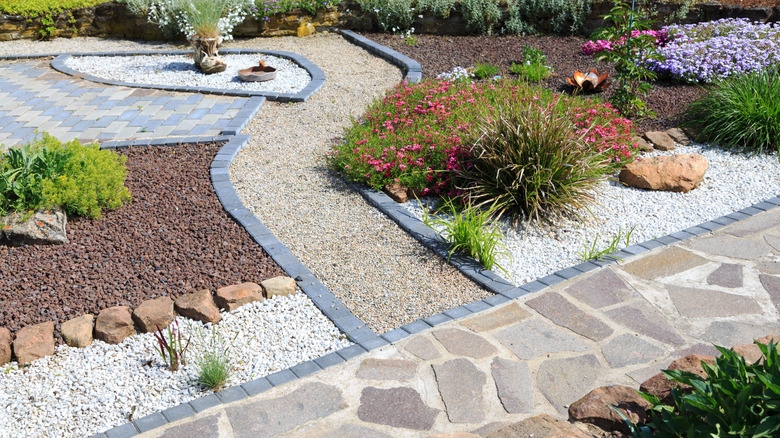 Rock garden with varied stones, gravel, and small shrubs and flowers