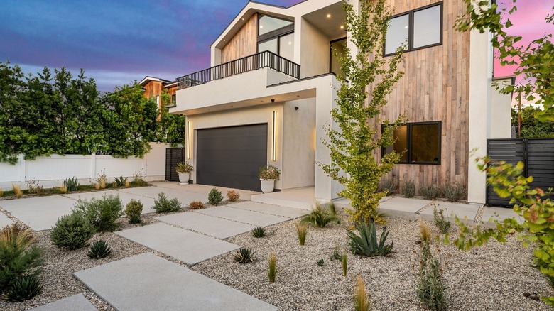 A gravel front yard with scattered drought-resistant plants