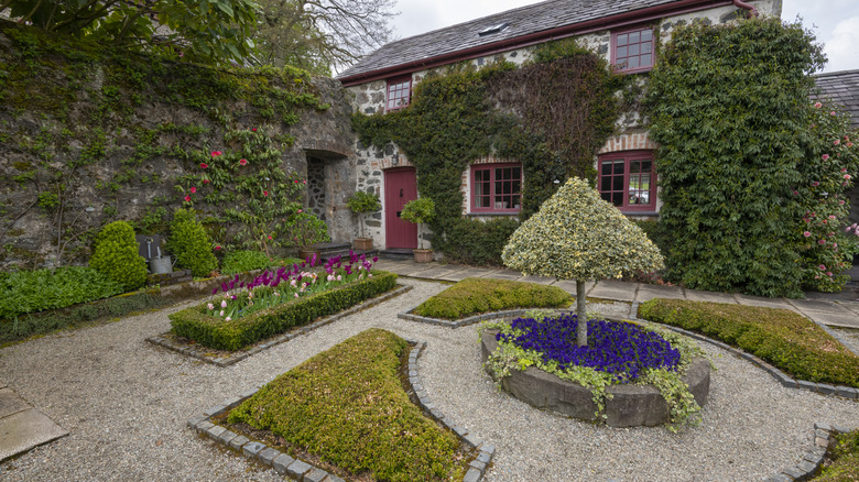 Gravey pathways around neat flower beds and patches of grass