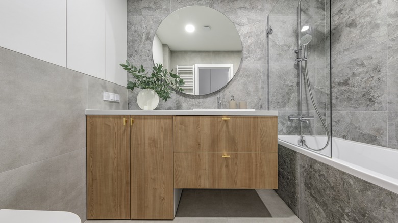 Wood cabinets in gray bathroom