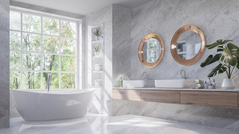 Gray bathroom with gold mirrors