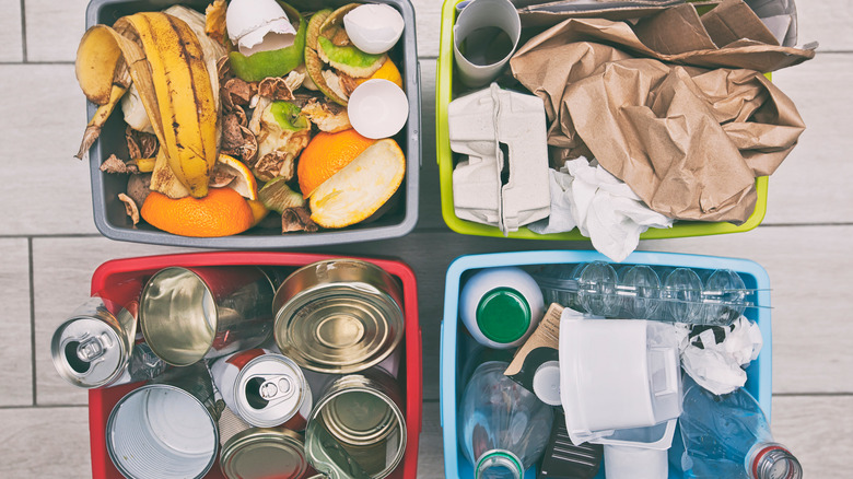 four recycling and compost bins