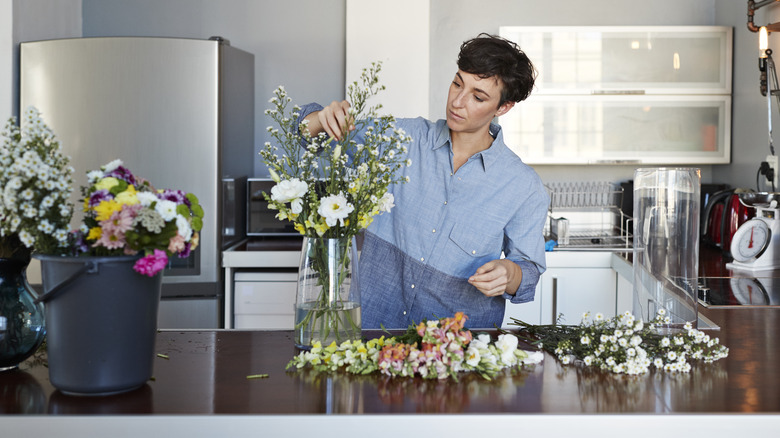 person creating flower bouquet