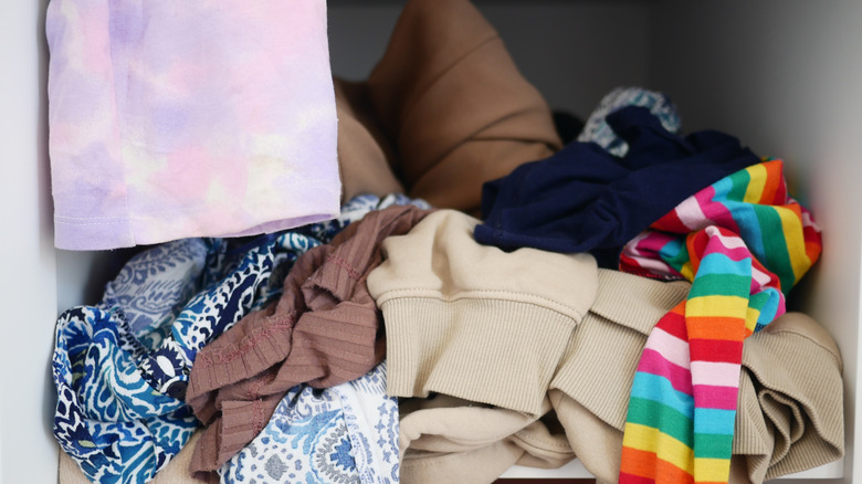 Messy pile of clothes in closet