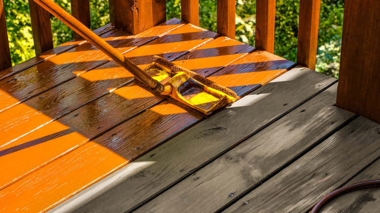 staining deck with paint roller