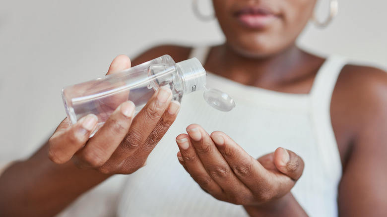 Woman using hand sanitizer