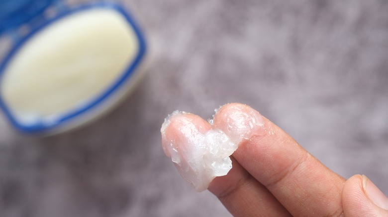 Fingers with petroleum jelly