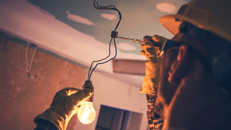 Man installing light bulb