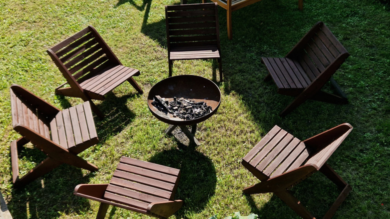 brown chairs around firepit