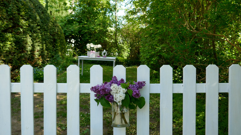 Picket fence with vase attached