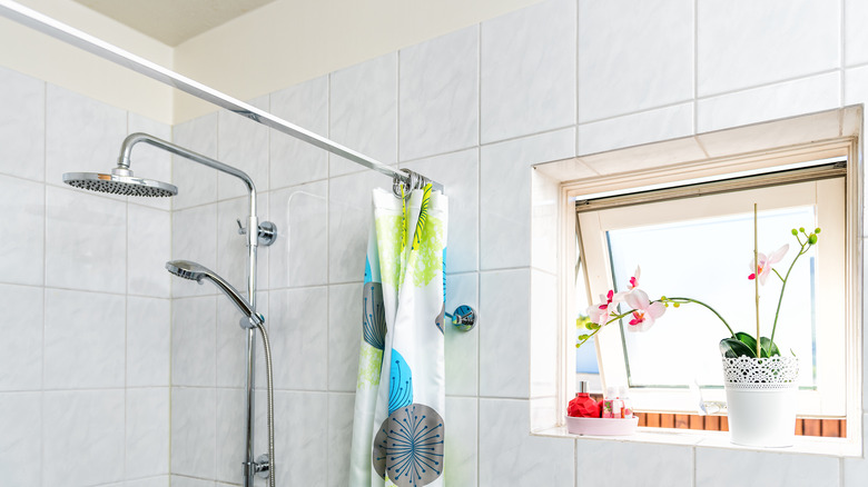 Tension rod hung shower curtain in bathroom