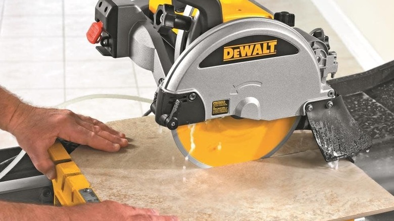 A person using a DeWalt 10-inch wet cut tile saw