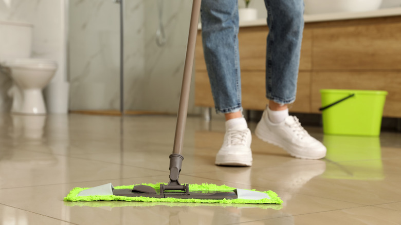 Person mopping tile floor