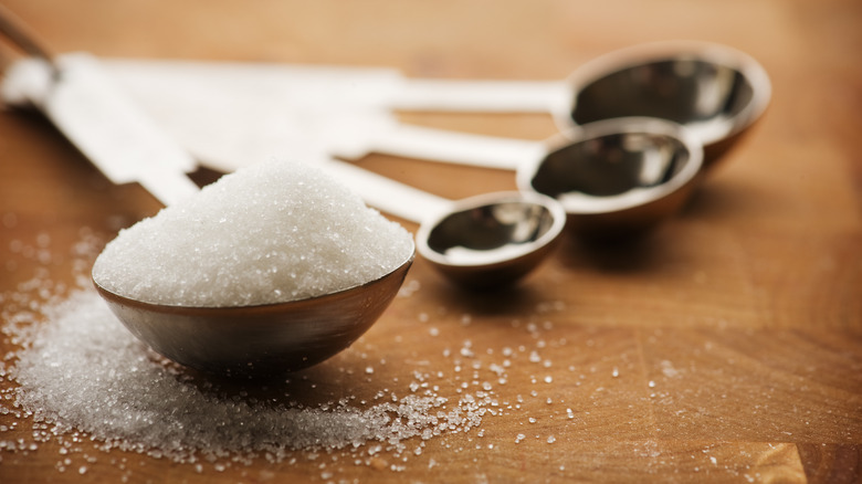 Measuring spoon with granulated sugar