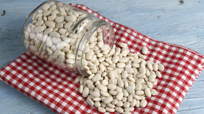 Jar with green bean seeds