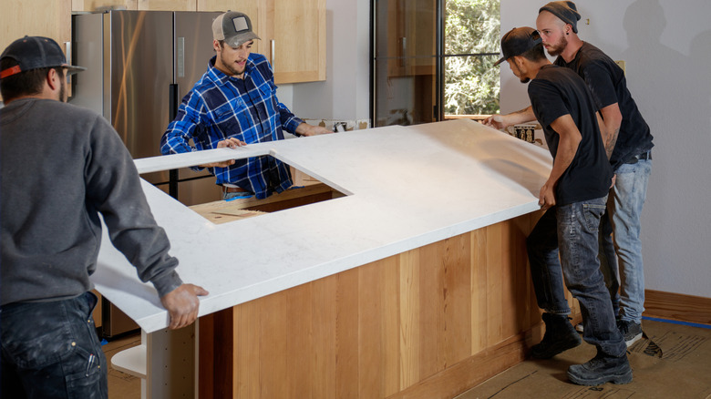 People installing a countertop