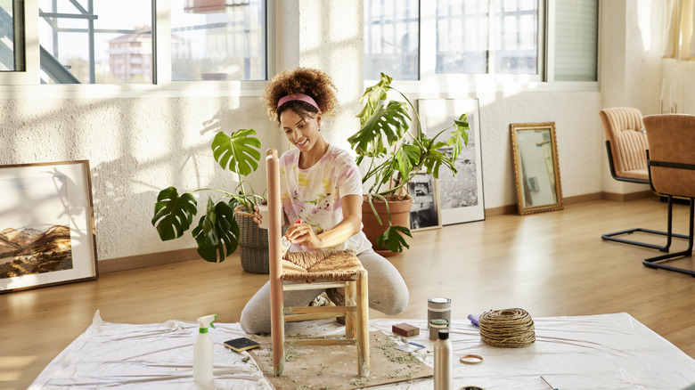 Woman painting chair