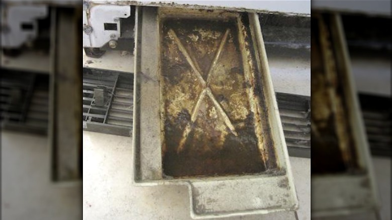 Dirty refrigerator drip pan