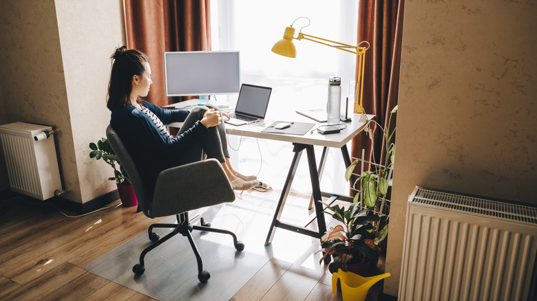 woman at desk near window