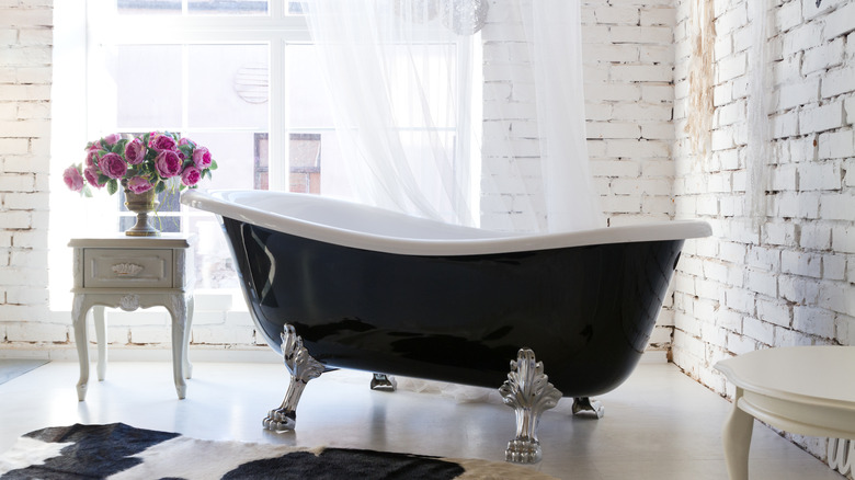 Old-fashioned bathtub near window