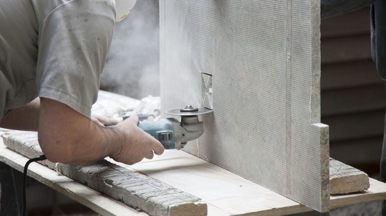 Man cutting granite slab