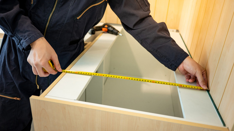 Man measuring countertops