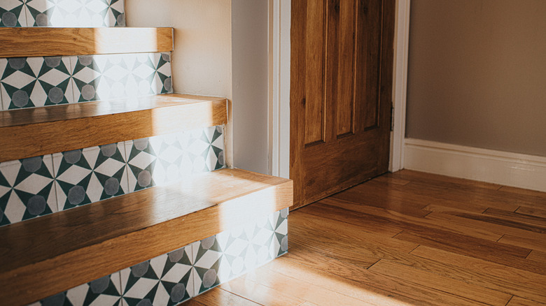 Home staircase with patterned wallpaper risers