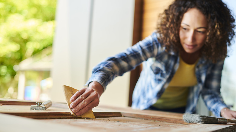 Woman sanding door