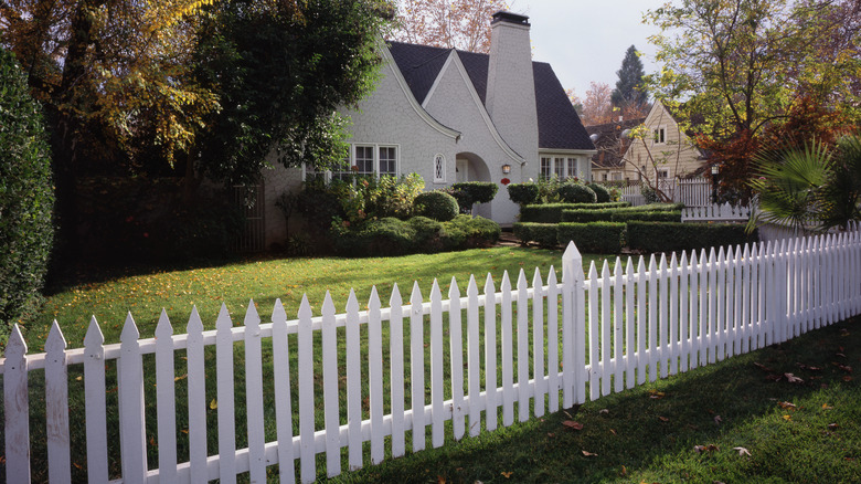 Attractive white picket fence in front of a house