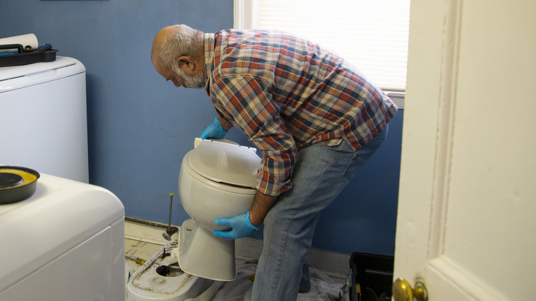Man removing toilet