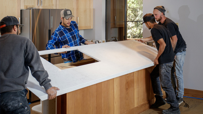 Workers installing countertop