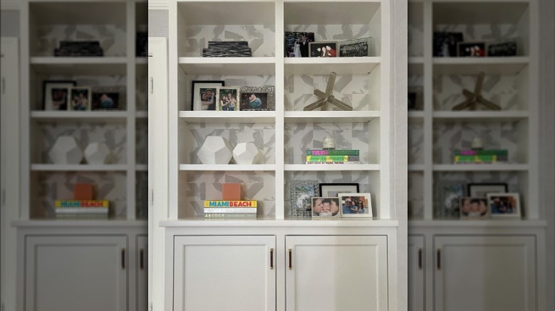 bookcase with wallpaper backdrop