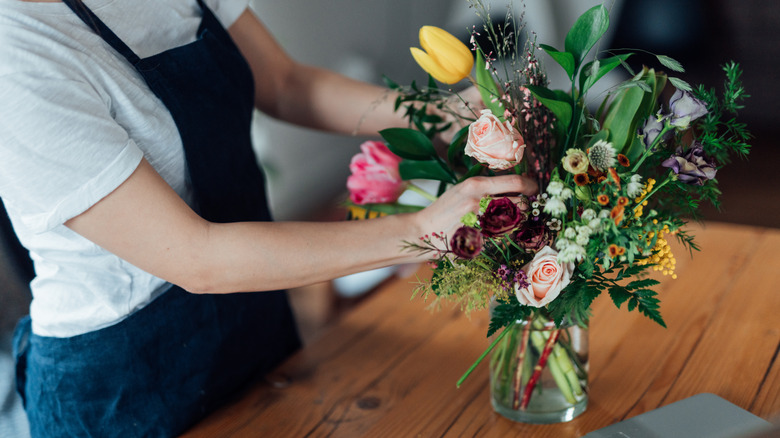 Person arranging cut flowers