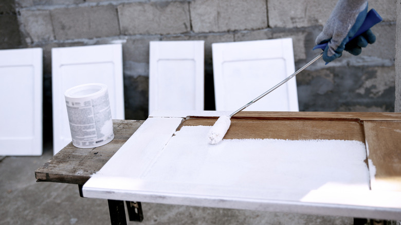 Wooden cabinet doors being painted white