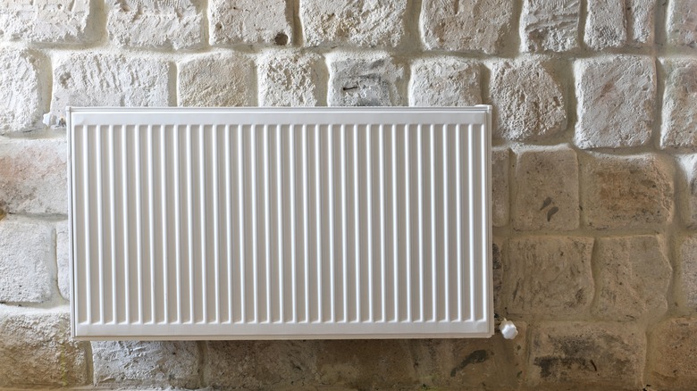 White radiator on stone wall