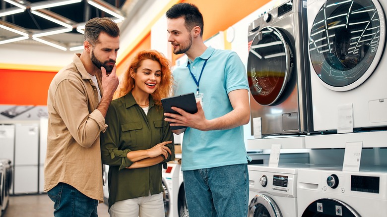 Couple and washing machine salesperson