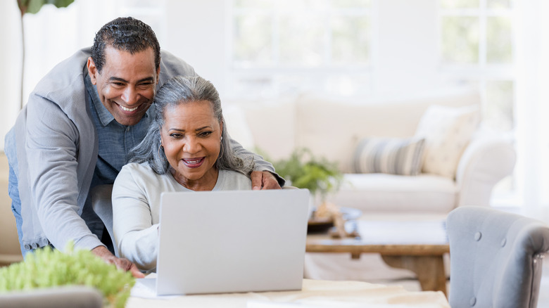 Couple smiling at computer