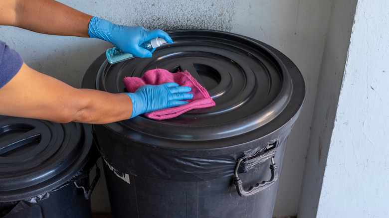 Person sanitizing garbage can 