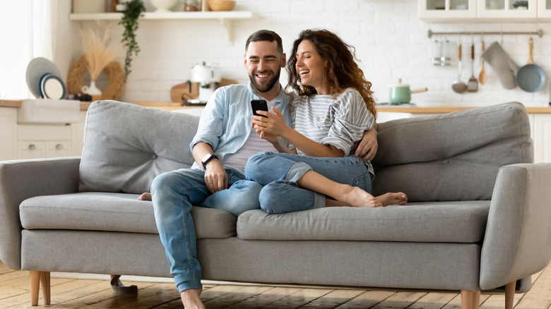 couple sitting on clean sofa