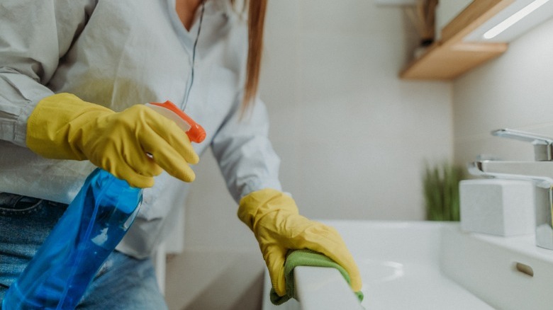 Woman cleaning the bathroom 